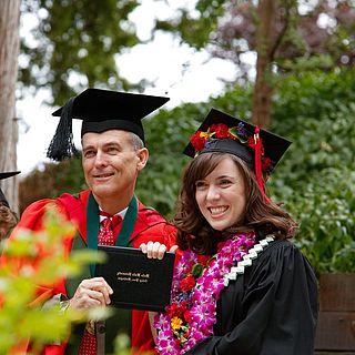 Photo of John McVay and his daughter smiling at graduation